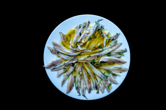 top view cenital of a tapa plate of boquerones en vinagre (pickled anchovies in vinegar)