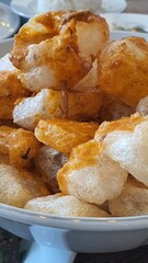 Skin crackers are served on a plate on the table mixed with curry sauce, usually found in Padang restaurants