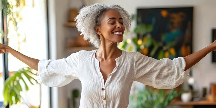 60-year-old woman dancing in living room