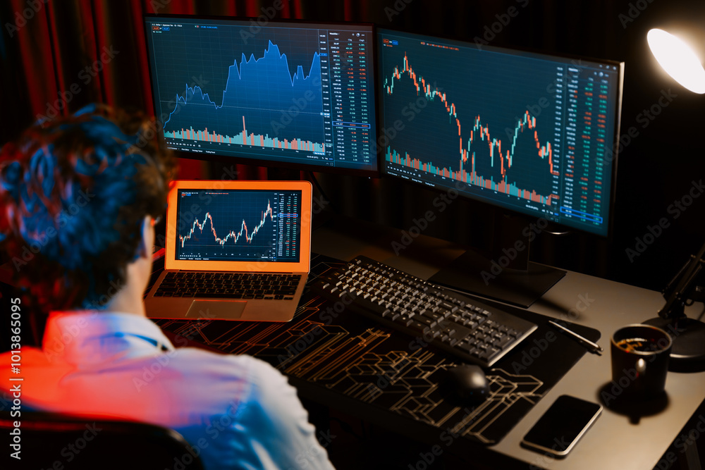 Poster young investor stock trader searching on laptop comparing with dynamic exchange rate screens of curr