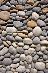 Rocks on the ground embedded in concrete on a city outskirt street island