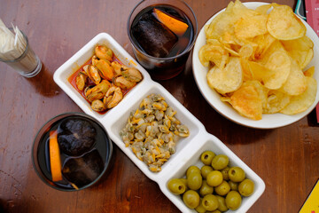 typical spanish aperitiv vermut before lunch with olives cockles mussels and chips