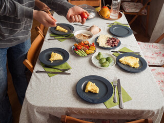 Serving the Omelette: Horizontal Shot of a Cozy Family Breakfast Preparation 
