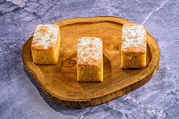 Three Cake Slices on Irregular Wooden Plate
