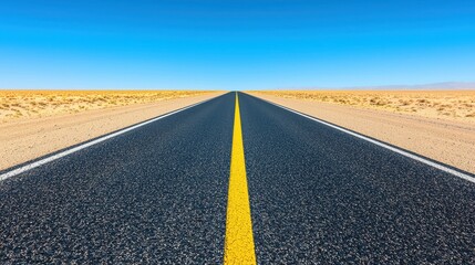 A long, empty road with a yellow line down the middle