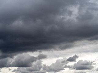Obraz premium Low gray rain clouds thicken in the sky. The sky before the rain