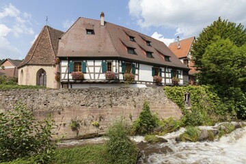 Oberhof Chapel and half-timbered houses on the river Weiss, Kaysersberg, Alsace, France, Europe