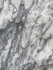 Uneven texture of gray stone with white streaks