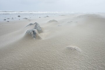 Stones and windblown sand on the sandy beach of Langeoog, East Frisia, Lower Saxony, Germany, Europe