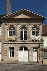 Fototapeta premium Former slaughterhouse with two bull figures on façade, Autun, Saône-et-Loire, France, Europe