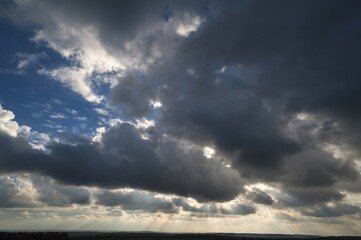 Obraz premium Sun behind rain clouds (Nimbostratus), Nuremberg Business Tower behind, Bavaria, Germany, Europe
