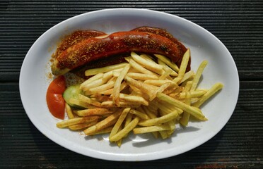Curry sausage with French fries on plates, Düsseldorf, North Rhine-Westphalia, Germany, Europe