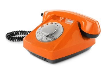 Old orange telephone with rotary dial isolated on white