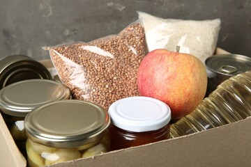 Different food products for donation in box, closeup