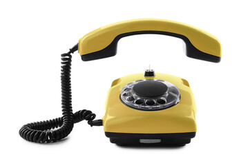 Old yellow telephone with rotary dial isolated on white