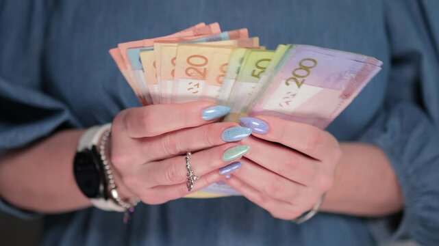 Female hands holding paper bills Belarusian rubles