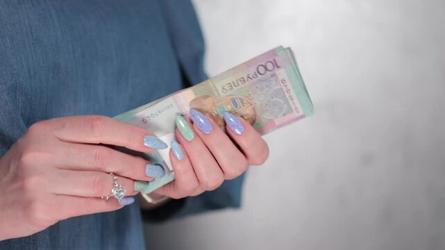 Female hands holding paper bills Belarusian rubles