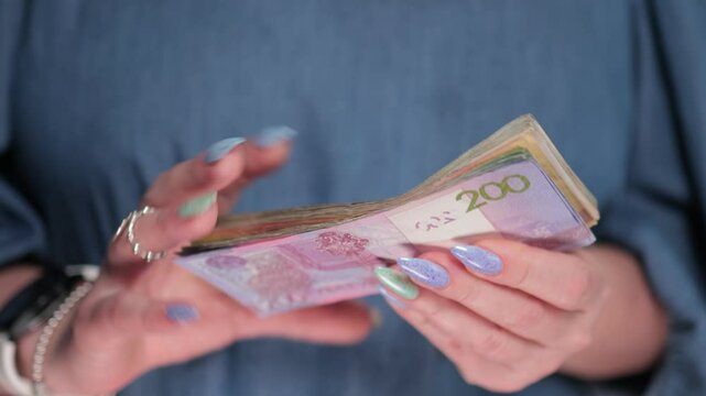 Female hands holding paper bills Belarusian rubles