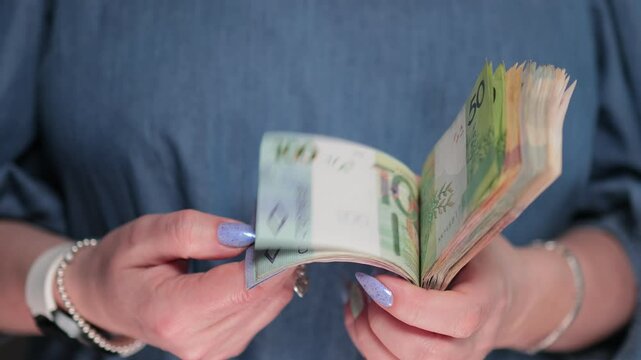 Female hands holding paper bills Belarusian rubles