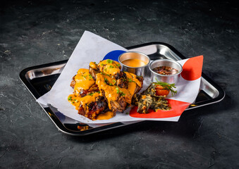 Grilled Peri Peri Chicken with Creamy Sauce and Crispy Garnish served in tray isolated on grey background side view of A la carte Food platter