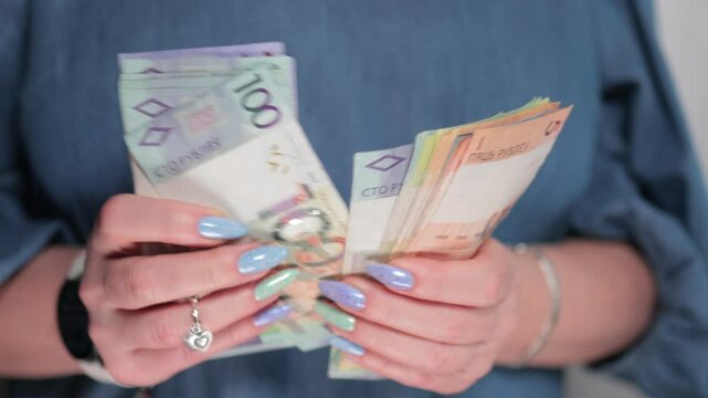 Female hands holding paper bills Belarusian rubles