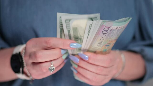 Female hands holding paper bills Belarusian rubles