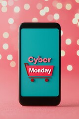 Mobile phone displaying Cyber Monday sale on festive background