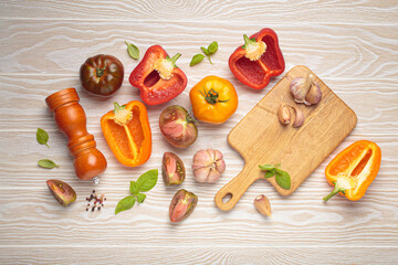Colorful vegetables, spices, pepper mill and herbs on a white table. Fresh, raw ingredients for...