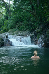 rear view of blonde woman bathing in Pozo Azul, Minca, Colombia