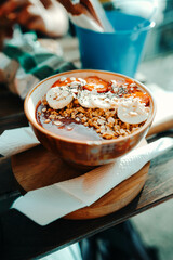 Bananas and strawberries in acai bowl at restaurant in Porto, Portugal
