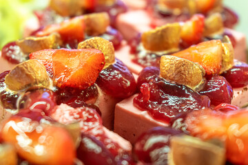 Fruit mousse pastries with berry jelly and fresh strawberries
