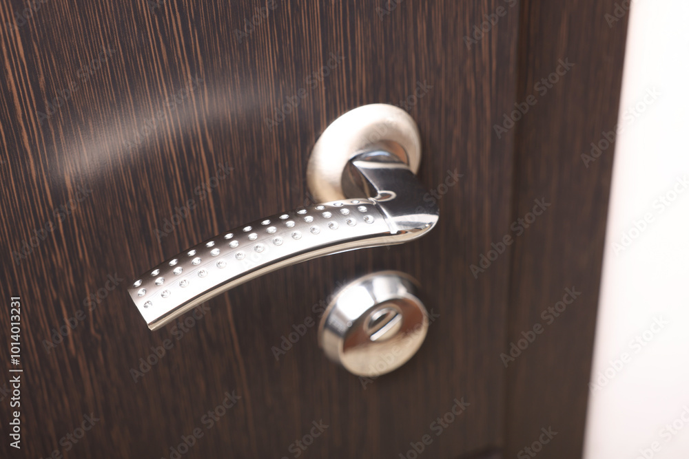 Sticker View of door with modern metal handle, closeup