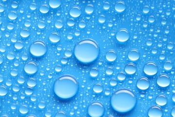 Water drops on blue background, above view