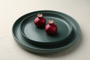 Stylish plates, salt and pepper shakers beige textured table, closeup