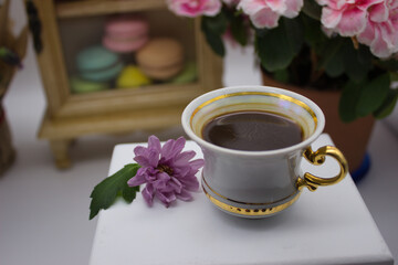 Elegant Tea Setting with Flowers and Colorful Macarons