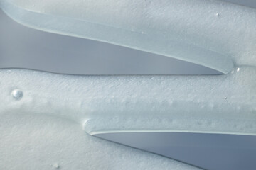close-up of cream on a blue sky with clouds background, cosmetics beauty product texture, shampoo,...