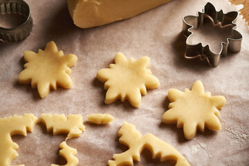 Star shapes cut out from pastry dough - preparation of Linzer Christmas cookies