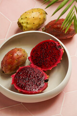 dragon fruit, also known as pitaya, cut open pink magenta-colored flesh with tiny black seeds, tropical fruits