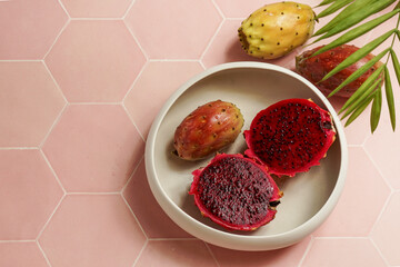 dragon fruit, also known as pitaya, cut open pink magenta-colored flesh with tiny black seeds, tropical fruits