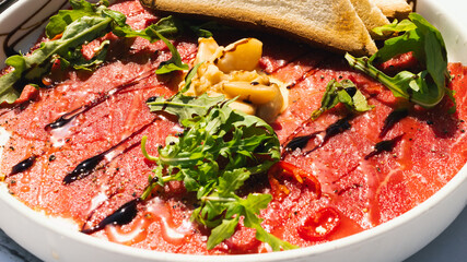 Chilled Beef carpaccio cold on white plate