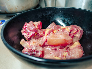 A closeup of a pile of fresh and raw meat on a bowl. ready to cook fresh meat
