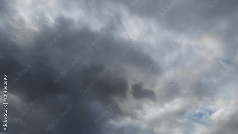 Wall mural time lapse looking up at grey storm clouds moving from left to right