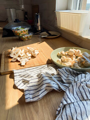 Sunlight in kitchen counter with freshly sliced mushrooms, cooking moment. Simplicity and beauty of food preparation in a home kitchen