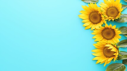 Vibrant sunflowers with green leaves against a bright blue background.