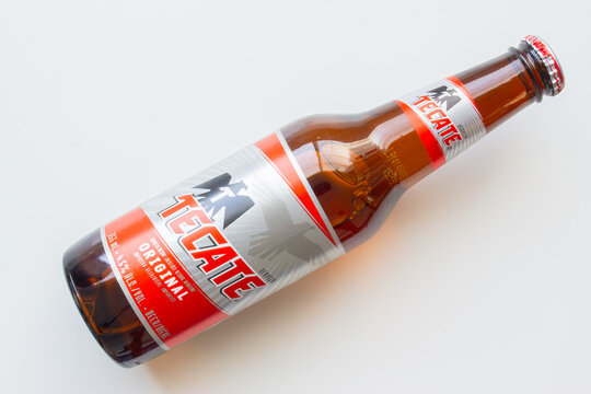 Calgary, Alberta, Canada. Oct 2, 2024. A top-down view of a Tecate Mexican beer bottle against a white background.