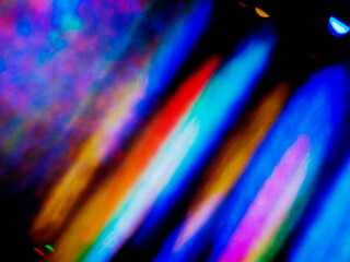 A colorful, blurry background with a rainbow of colors. The colors are bright and vibrant, creating...