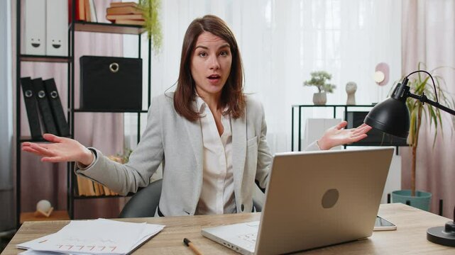 I don't know what to say. Confused businesswoman working on laptop at home office desk. Freelancer feeling embarrassed about ambiguous question having doubts, no answer idea, being clueless, uncertain