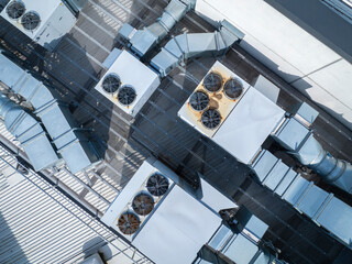 Aerial: Top down shot of Air Conditioning And Ventilation Systems Installed On The Roof