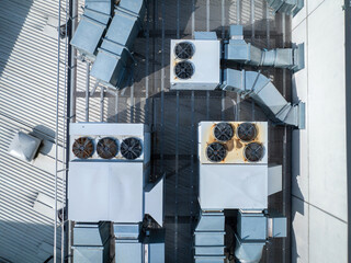 Aerial: Top down shot of Air Conditioning And Ventilation Systems Installed On The Roof