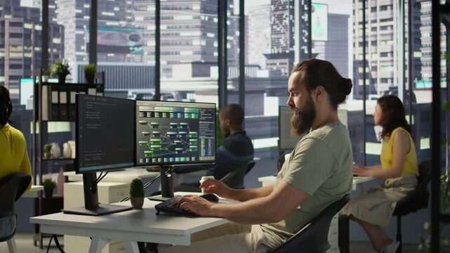 Developer working with artificial intelligence machine learning tech, improving company systems. IT expert in office focused on transforming data into predictive models, camera B